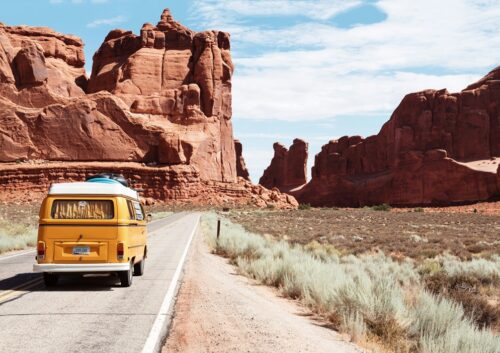 A van driving down a canyon road.